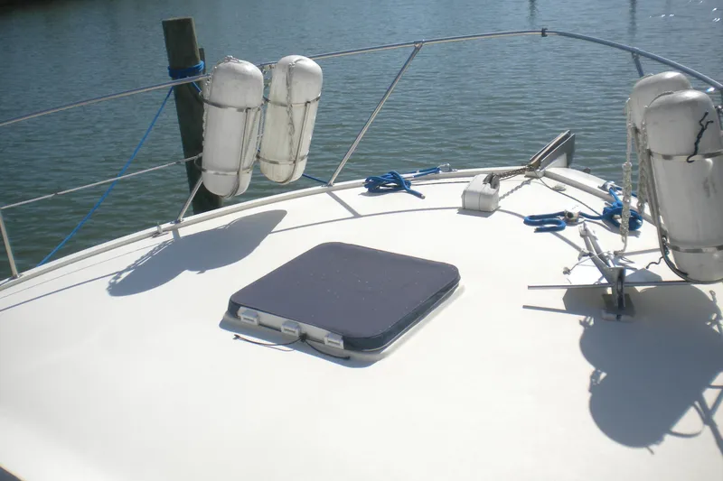 Slide: The Image of Bow deck of 1987 Hatteras 40 Motor Yacht with fenders and hatch. - 24