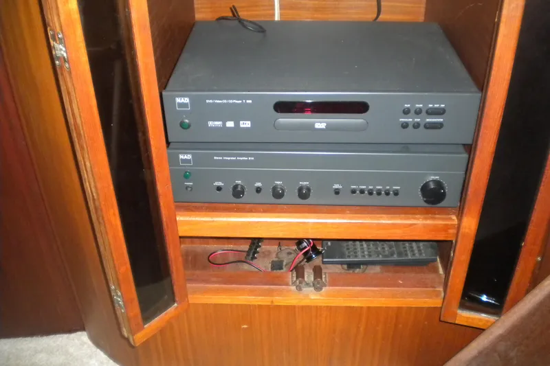 Slide: The Image of Audio equipment in a wooden cabinet on a 1987 Hatteras 40 Motor Yacht. - 25