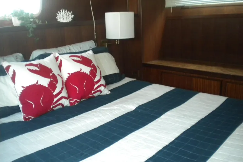 Slide: The Image of Cozy bedroom in 1987 Hatteras 40 Motor Yacht with nautical-themed decor. - 28