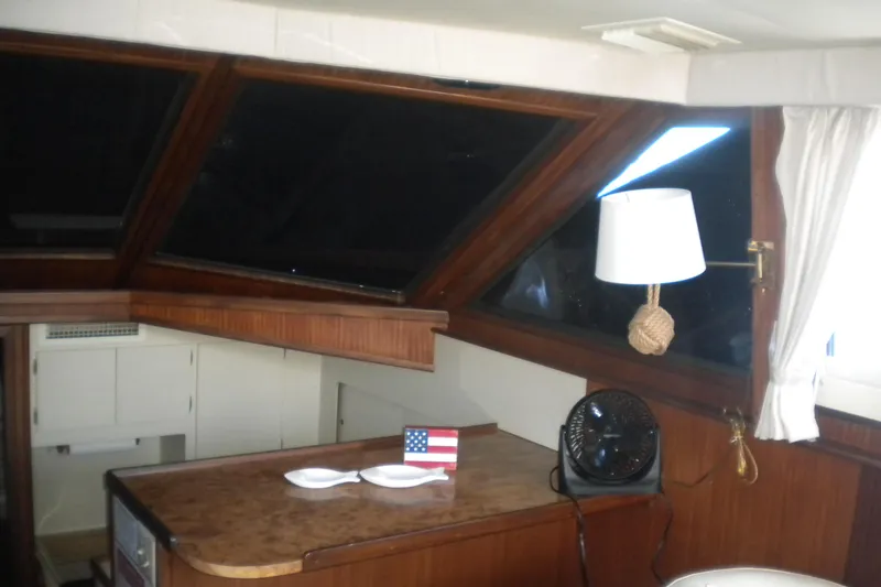 Slide: The Image of Interior of 1987 Hatteras 40 Motor Yacht with wooden accents and nautical decor. - 31