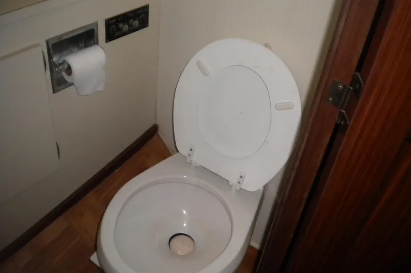 Slide: The Image of Toilet in 1987 Hatteras 40 Motor Yacht bathroom with wooden flooring. - 34