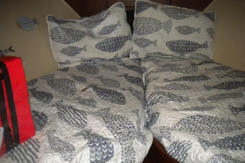 Slide: The Image of Twin beds with fish-patterned bedding in a 1987 Hatteras 40 Motor Yacht cabin. - 35