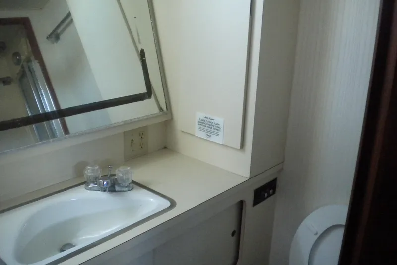 Slide: The Image of Bathroom interior of 1987 Hatteras 40 Motor Yacht with sink and mirror. - 39