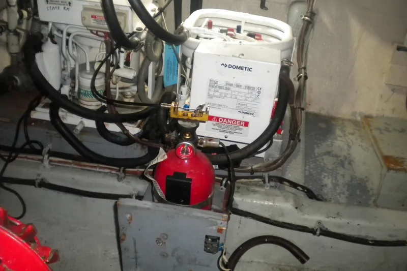 Slide: The Image of Engine room of 1987 Hatteras 40 Motor Yacht with Dometic equipment and fire extinguisher. - 40