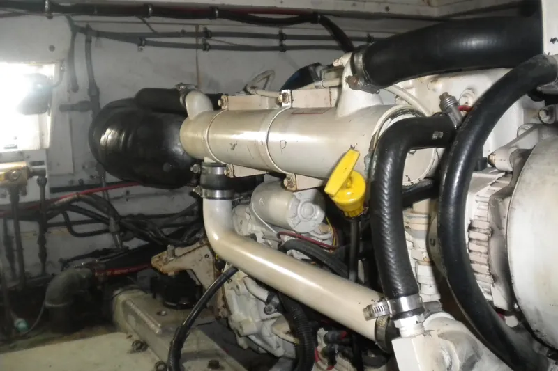 Slide: The Image of Engine room of a 1987 Hatteras 40 Motor Yacht, showcasing mechanical components and hoses. - 41