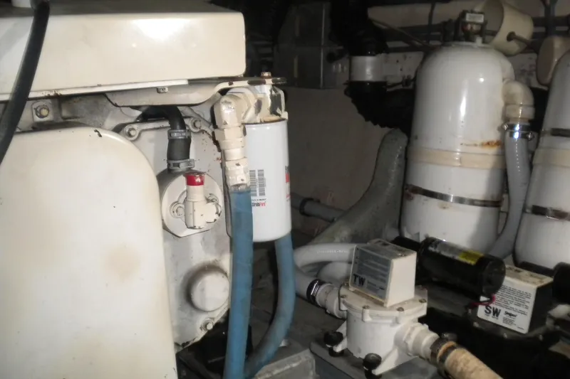 Slide: The Image of Engine room of 1987 Hatteras 40 Motor Yacht with mechanical components and filters. - 42