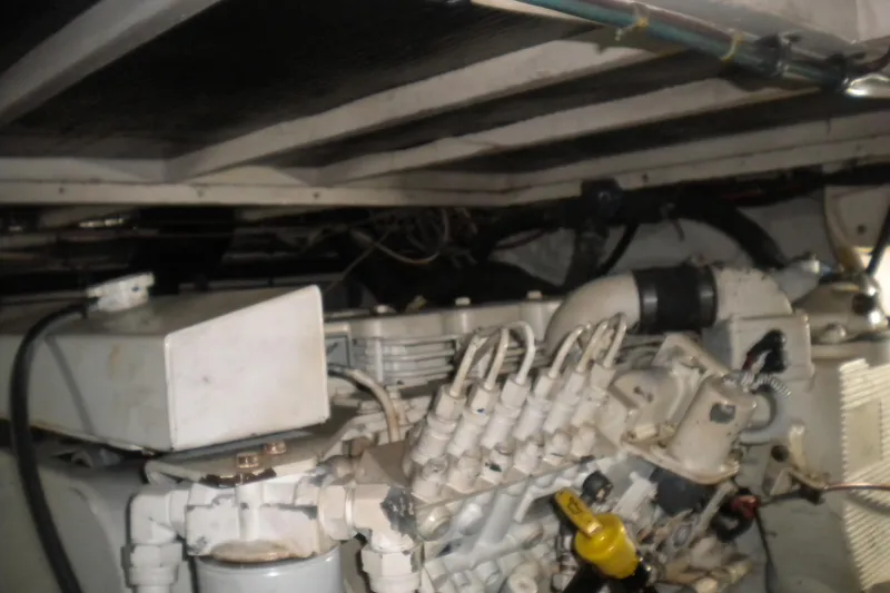 Slide: The Image of Engine room of a 1987 Hatteras 40 Motor Yacht, showcasing mechanical components. - 43