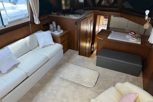 Slide: The Image of Interior of 1987 Hatteras 40 Motor Yacht with cozy seating and modern amenities. - 6