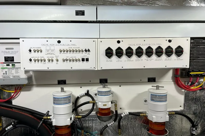 Slide: The Image of Engine room distribution panel of 2021 Cruisers Yachts 50 Cantius with battery charger and filters. - 101