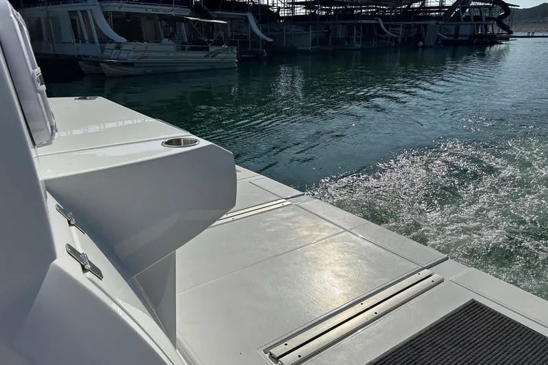 Slide: The Image of 2021 Cruisers Yachts 50 Cantius docked, showcasing sleek deck design and marina view. - 28