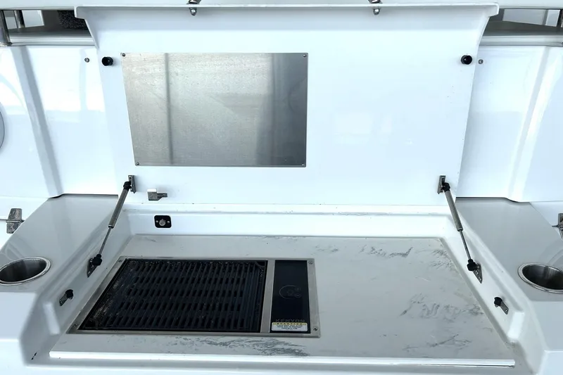 Slide: The Image of Outdoor grill station on 2021 Cruisers Yachts 50 Cantius, featuring stainless steel and cup holders. - 29