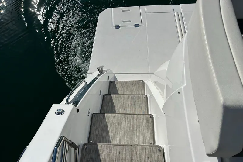 Slide: The Image of 2021 Cruisers Yachts 50 Cantius swim platform and steps, reflecting sunlight on water. - 32