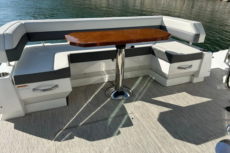 Slide: The Image of 2021 Cruisers Yachts 50 Cantius seating area with elegant wooden table on deck. - 35