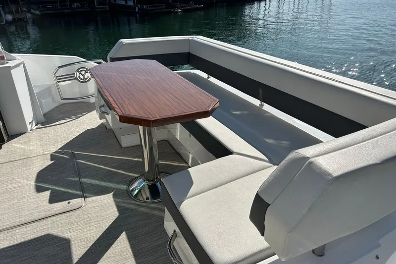 Slide: The Image of Luxury seating area on 2021 Cruisers Yachts 50 Cantius, featuring elegant wood table. - 36