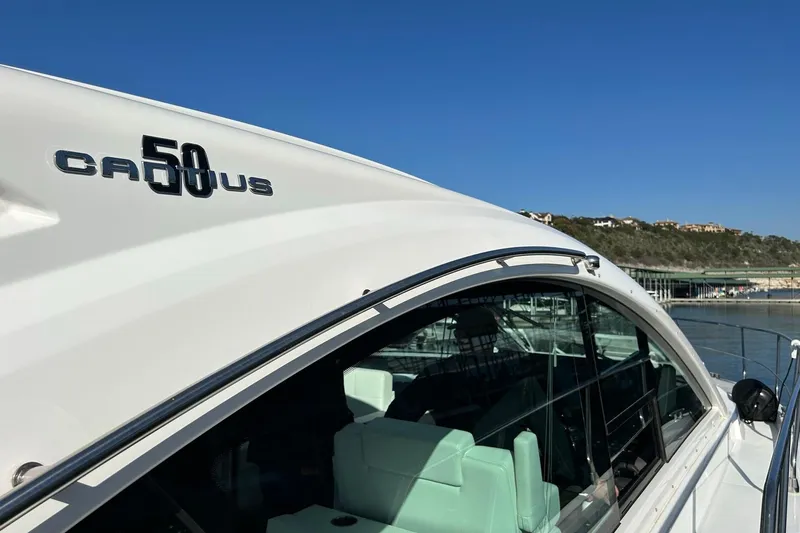 Slide: The Image of 2021 Cruisers Yachts 50 Cantius, sleek design, docked under clear blue sky. - 39