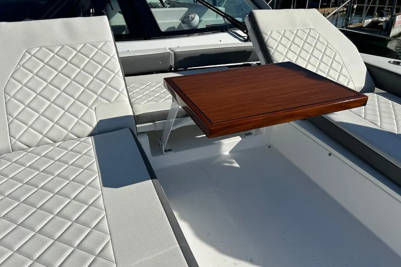 Slide: The Image of Luxurious seating area on 2021 Cruisers Yachts 50 Cantius with elegant wooden table. - 42