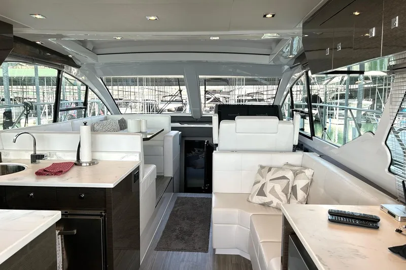 Slide: The Image of Luxurious interior of 2021 Cruisers Yachts 50 Cantius with modern seating and kitchen area. - 45