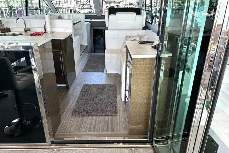 Slide: The Image of Luxurious interior of 2021 Cruisers Yachts 50 Cantius with modern kitchen and seating area. - 46