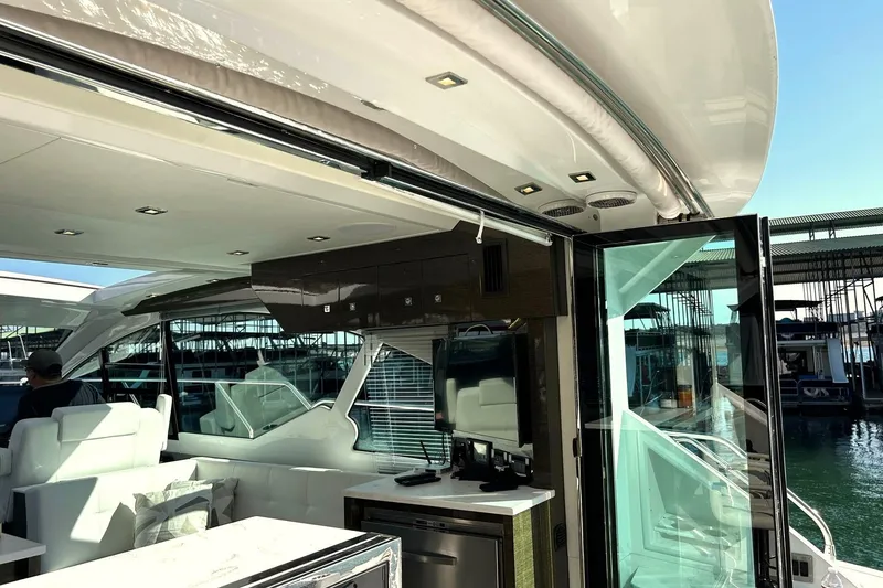 Slide: The Image of 2021 Cruisers Yachts 50 Cantius interior with modern design and marina view. - 48