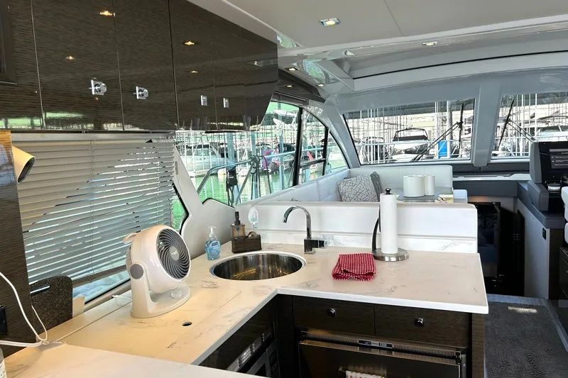 Slide: The Image of Luxurious interior of 2021 Cruisers Yachts 50 Cantius with modern kitchen and seating area. - 53