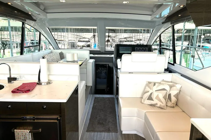 Slide: The Image of 2021 Cruisers Yachts 50 Cantius interior with modern seating, kitchen, and helm. - 6