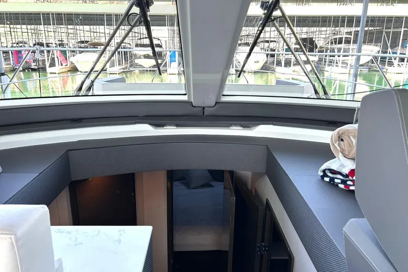 Slide: The Image of Interior view of 2021 Cruisers Yachts 50 Cantius, showcasing cabin entrance and docked boats outside. - 68