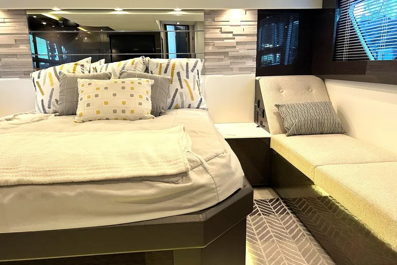 Slide: The Image of Luxurious 2021 Cruisers Yachts 50 Cantius bedroom with modern decor and cozy seating area. - 8