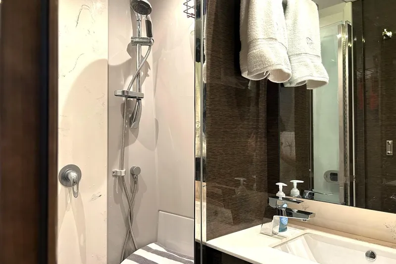 Slide: The Image of Luxurious bathroom in 2021 Cruisers Yachts 50 Cantius, featuring modern shower and sink. - 81