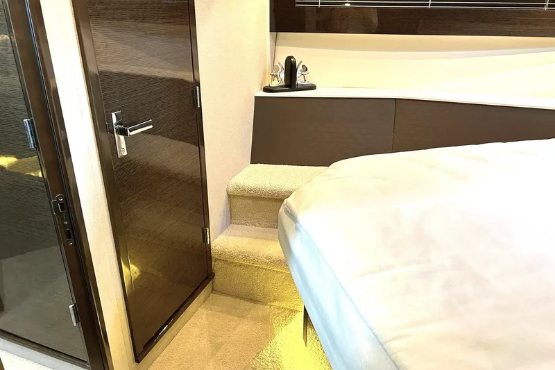 Slide: The Image of Luxurious interior of 2021 Cruisers Yachts 50 Cantius with elegant wood finishes and cozy bedding. - 87