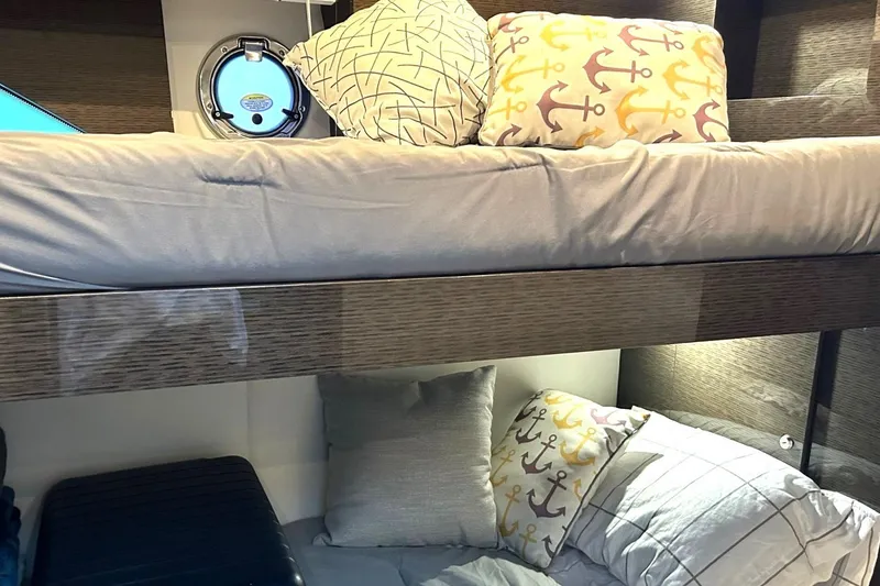 Slide: The Image of Bunk beds in 2021 Cruisers Yachts 50 Cantius, featuring anchor-themed pillows. - 93
