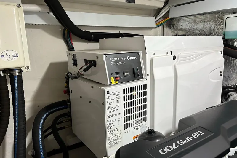 Slide: The Image of Cummins Onan generator in 2021 Cruisers Yachts 50 Cantius engine room. - 99