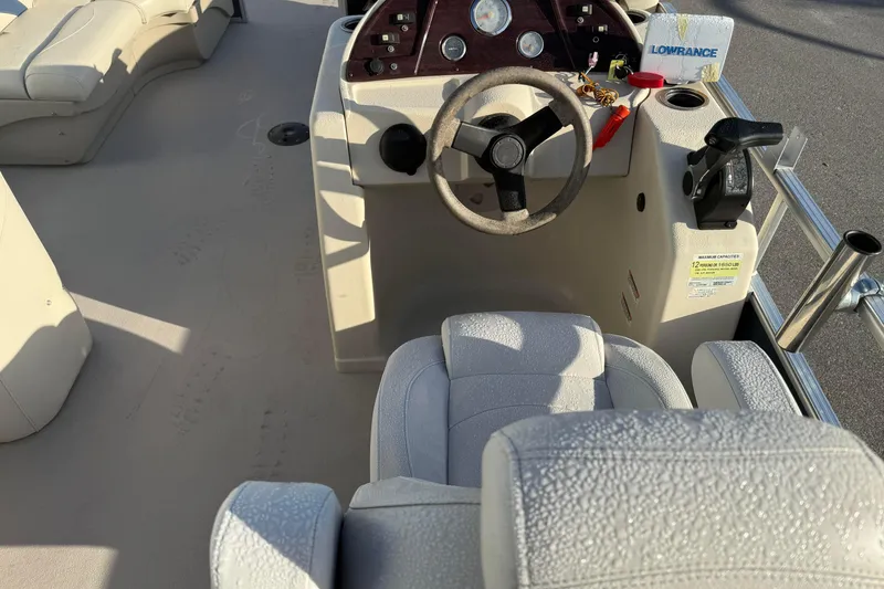Slide: The Image of Interior of a 2015 SunChaser 22 vs boat with steering wheel and seating. - 11