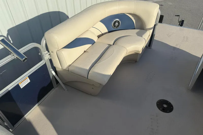 Slide: The Image of 2015 SunChaser 22 VS boat interior with beige seating and blue accents. - 12