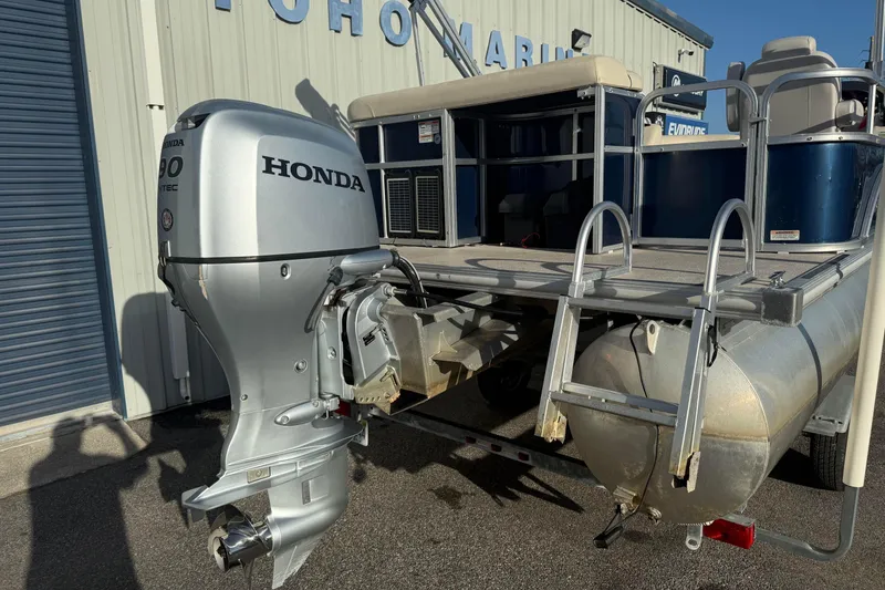 Slide: The Image of 2015 SunChaser 22 vs pontoon boat with Honda outboard motor at marina. - 2