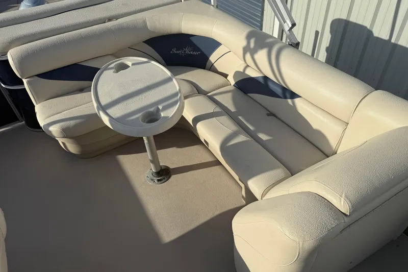 Slide: The Image of 2015 SunChaser 22 vs boat interior with beige seating and round table. - 8