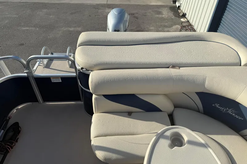 Slide: The Image of 2015 SunChaser 22 vs pontoon boat with beige seating and outboard motor. - 9