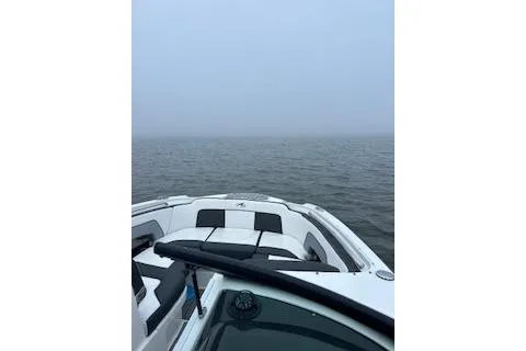Slide: The Image of 2022 Monterey boat on calm, foggy waters with overcast sky. - 5