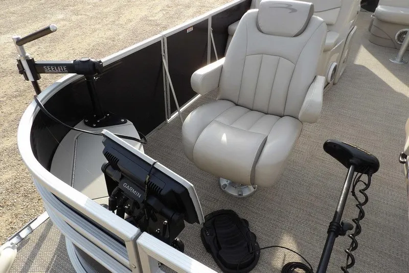 Slide: The Image of 2018 Bennington 23SF boat interior with captain's chair, Garmin device, and Seelite equipment. - 10