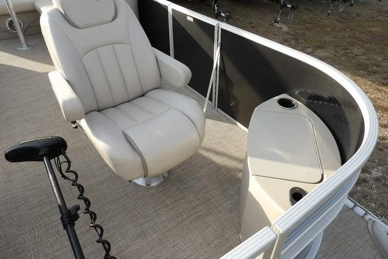 Slide: The Image of 2018 Bennington 23SF boat interior with beige captain's chair and console. - 12