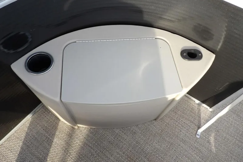 Slide: The Image of 2018 Bennington 23SF boat console with cup holders and storage compartment. - 23