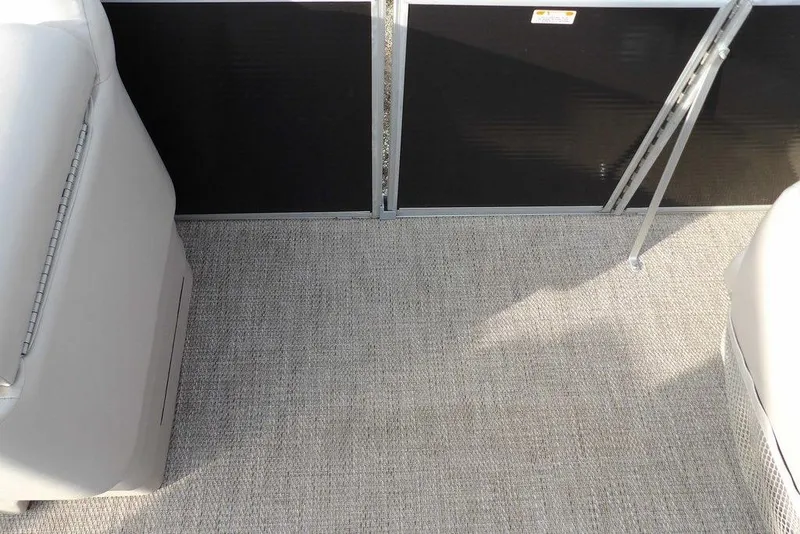 Slide: The Image of 2018 Bennington 23SF boat interior with gray carpet and seating. - 24