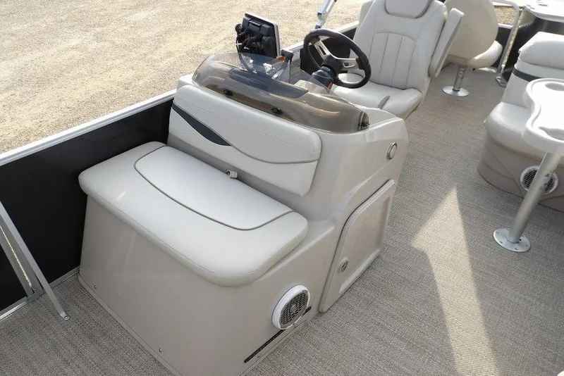 Slide: The Image of 2018 Bennington 23SF boat interior with beige seating and steering console. - 25