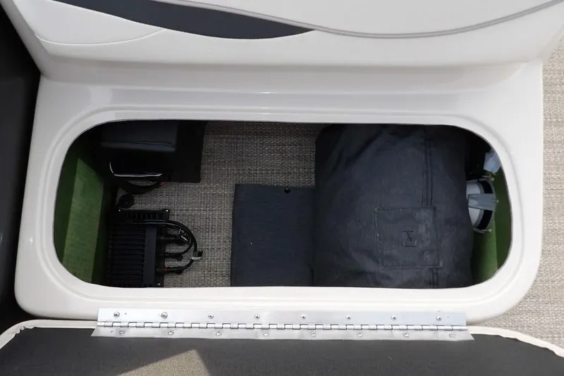 Slide: The Image of Storage compartment in a 2018 Bennington 23SF boat, featuring organized equipment and accessories. - 26