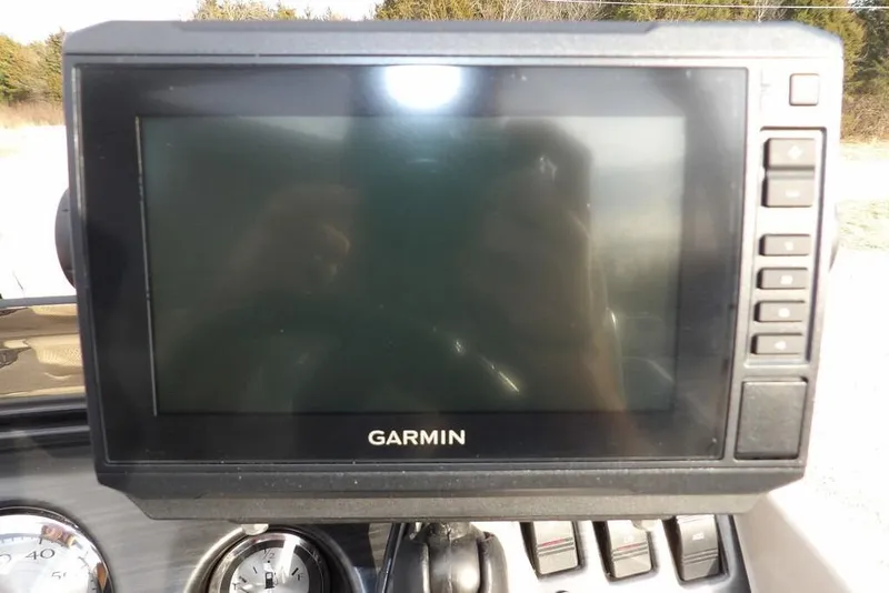 Slide: The Image of Garmin display on 2018 Bennington 23SF boat dashboard with control buttons. - 35