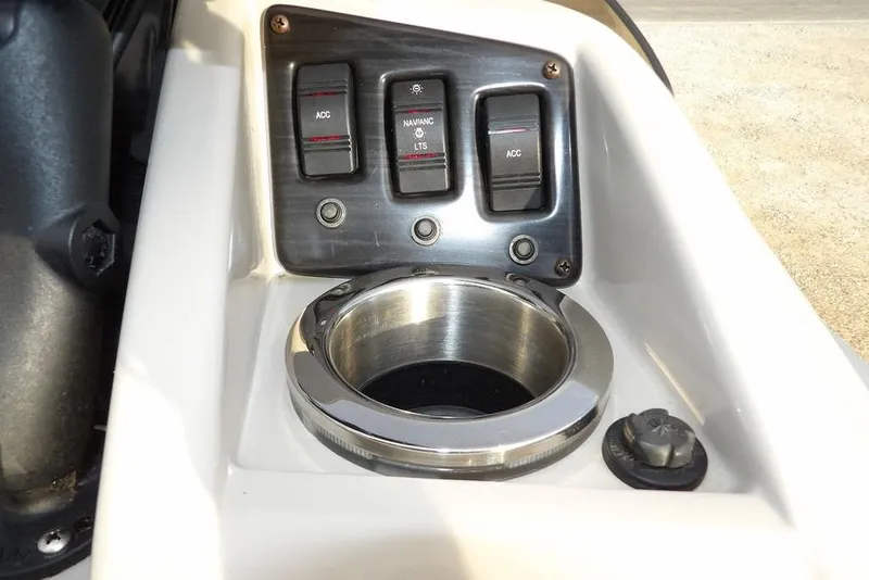 Slide: The Image of Control panel of a 2018 Bennington 23SF boat with switches and cup holder. - 36