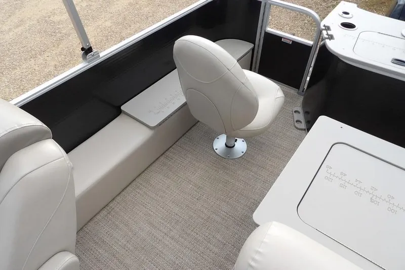 Slide: The Image of 2018 Bennington 23SF boat interior with beige seating and carpeted flooring. - 46