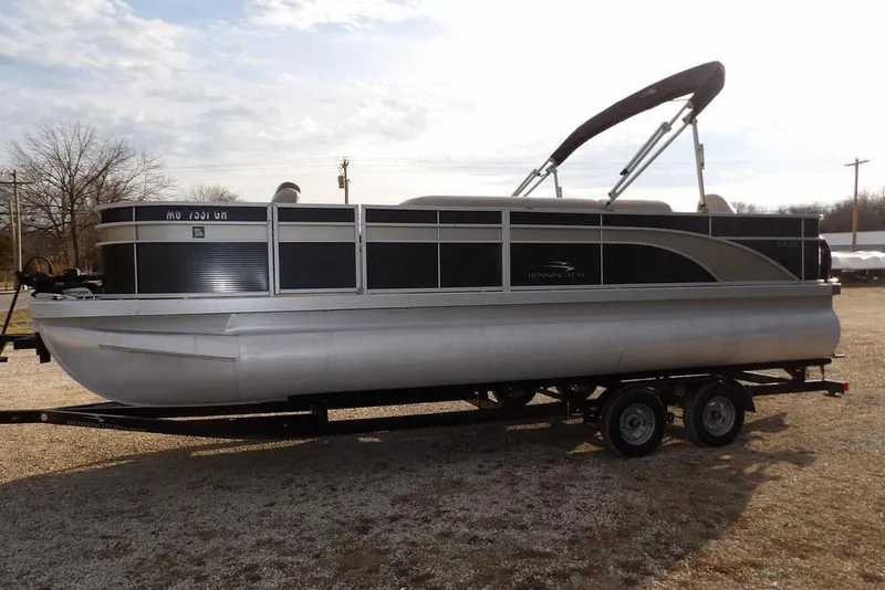 Slide: The Image of 2018 Bennington 23SF pontoon boat on trailer under cloudy sky. - 5
