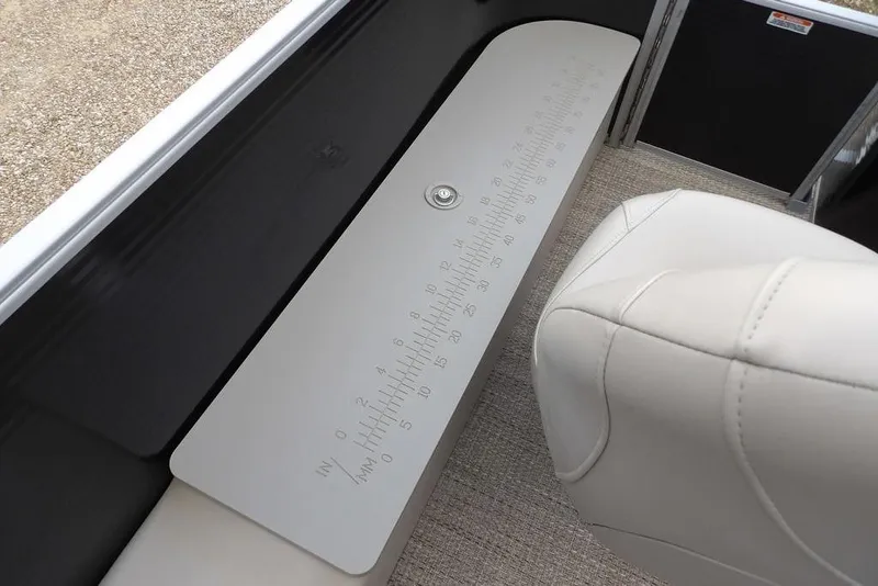 Slide: The Image of 2018 Bennington 23SF boat interior with measuring board and beige seating. - 50