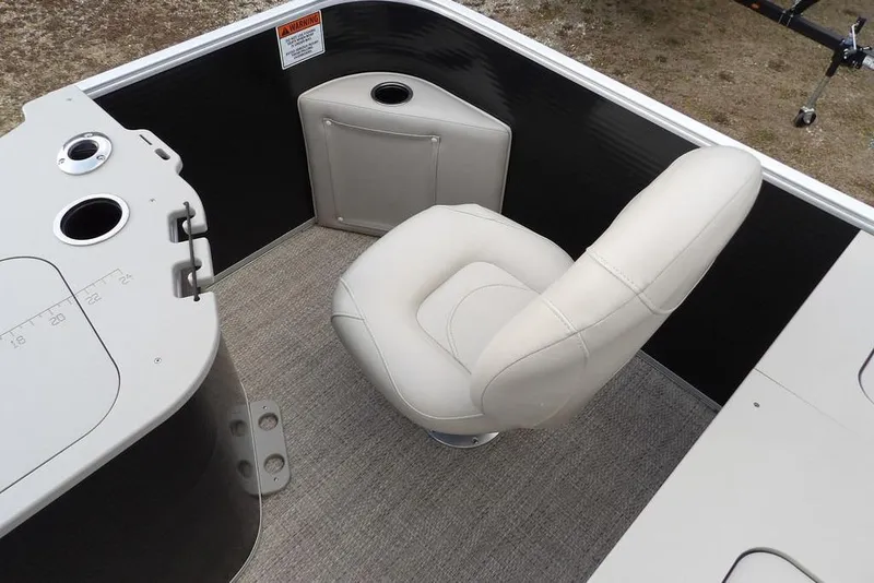 Slide: The Image of 2018 Bennington 23SF boat interior with beige captain's chair and control panel. - 51