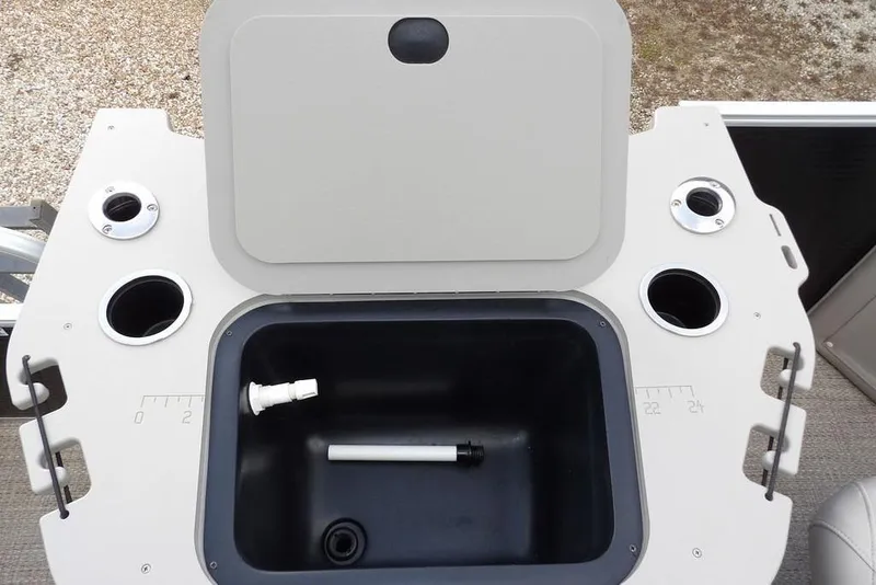 Slide: The Image of 2018 Bennington 23SF boat livewell with open lid and cup holders. - 53